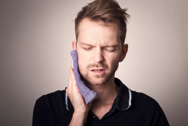 a man suffering from tooth pain